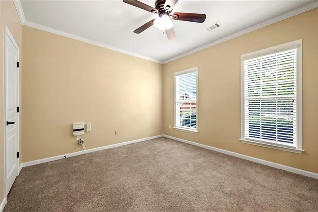a view of a livingroom with a ceiling fan and window