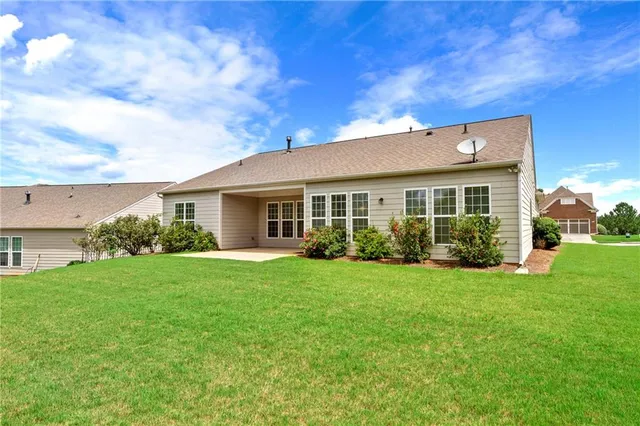 a view of a house with a backyard