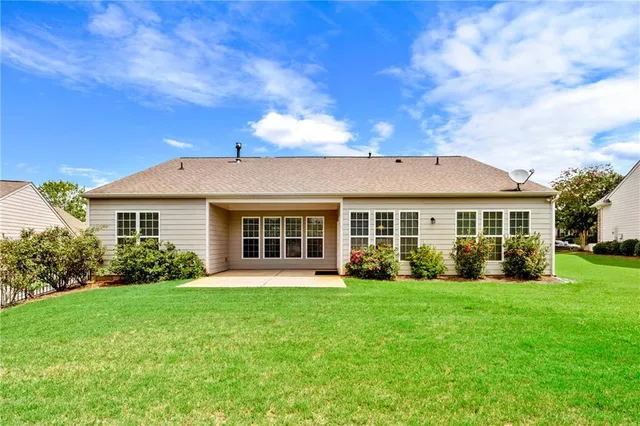a front view of house with yard and green space