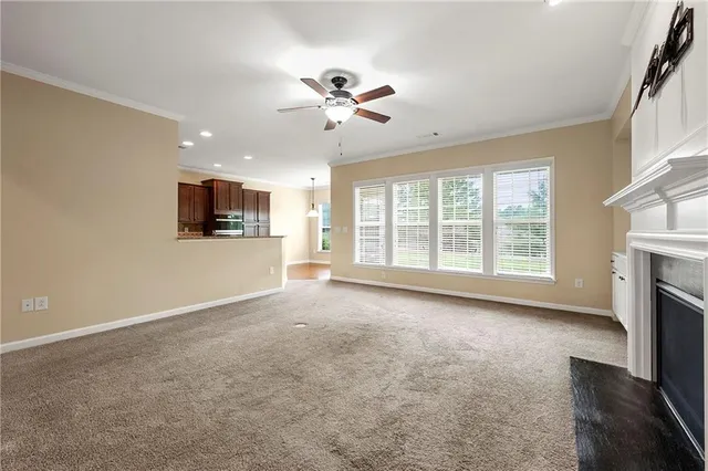 a view of livingroom with fireplace fan and window