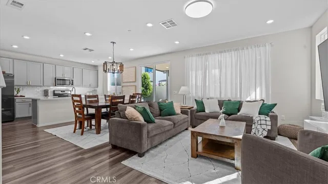 a living room with furniture kitchen and a table