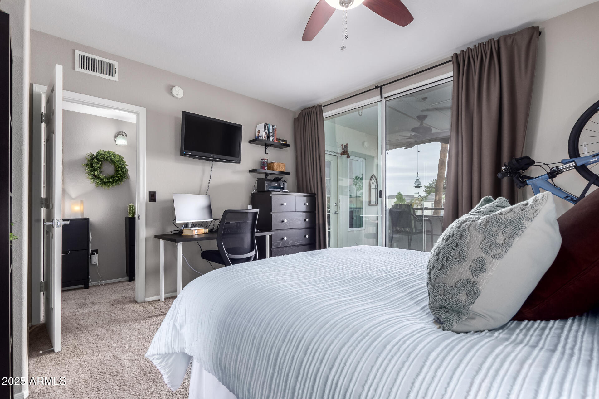 1825 West Ray Road, Unit 2116 Chandler, AZ 85224 - Photo 15 of 44 a bedroom with a bed a flat screen tv and a chandelier