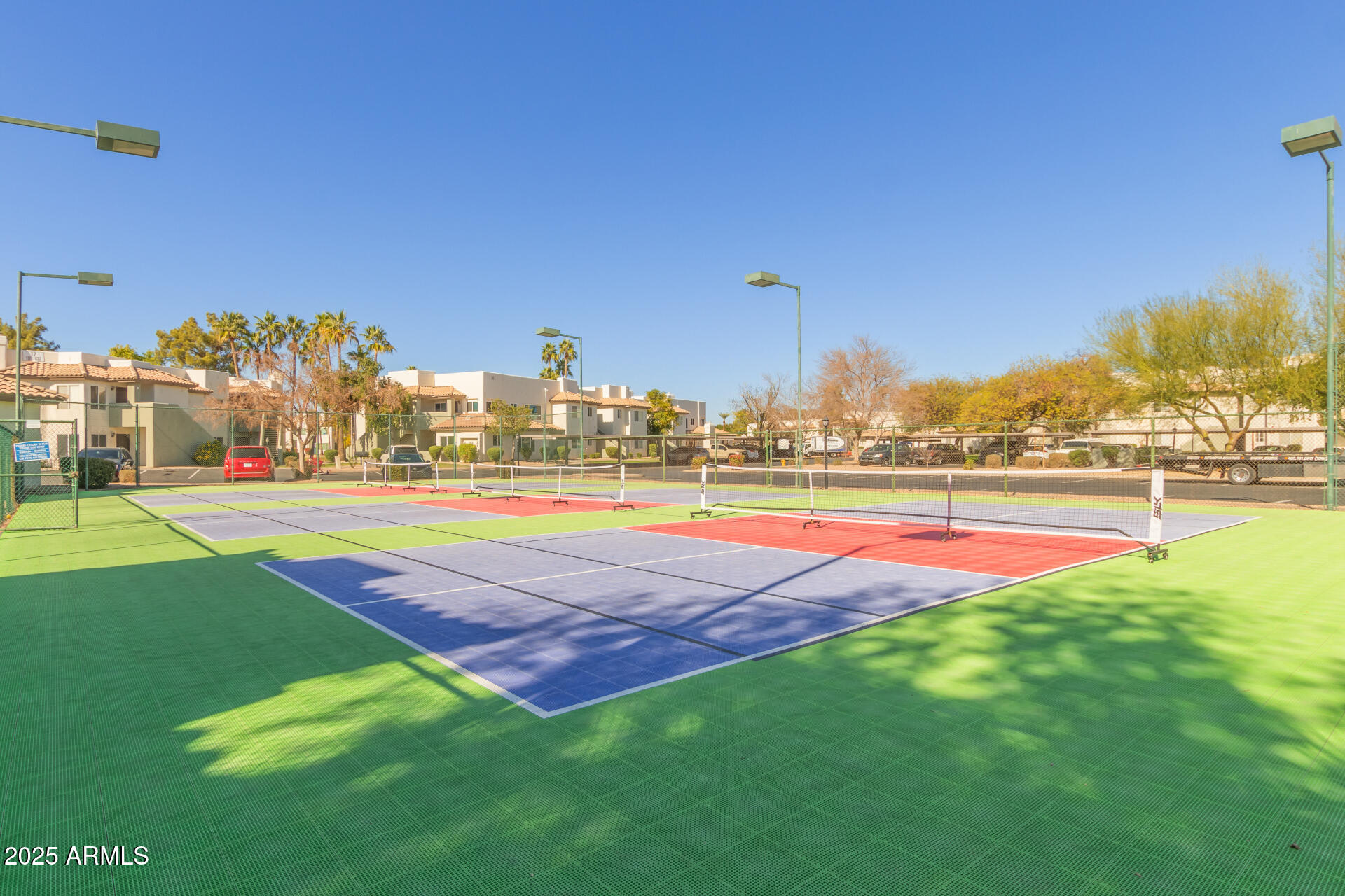 1825 West Ray Road, Unit 2116 Chandler, AZ 85224 - Photo 29 of 44 a view of an outdoor space and tennis court