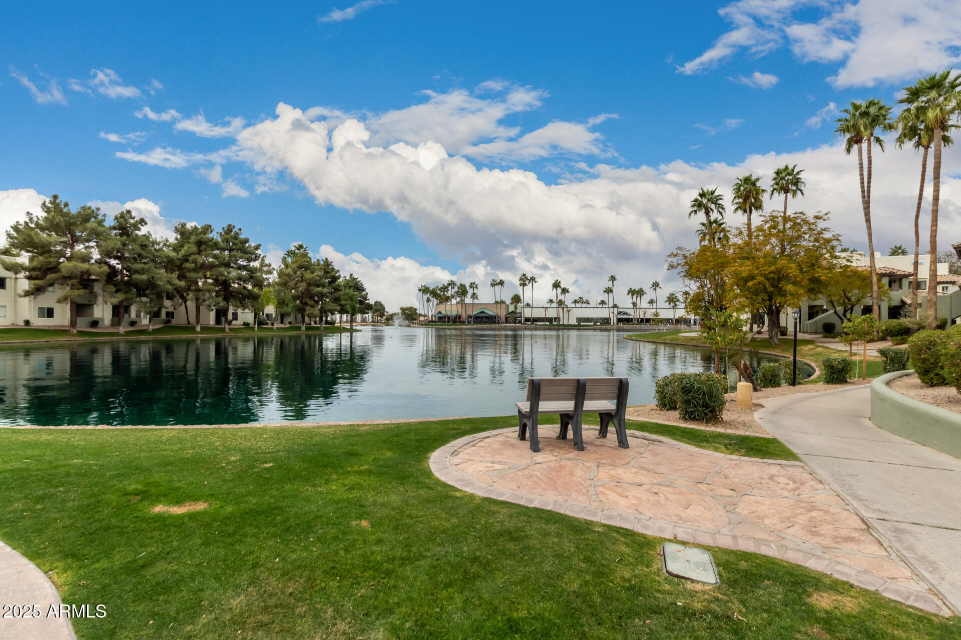 1825 West Ray Road, Unit 2116 Chandler, AZ 85224 - Photo 38 of 44 a lake view with a bench and lake view