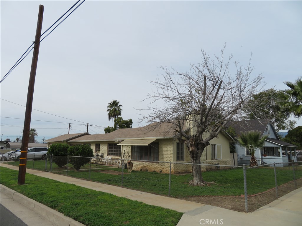 903 Ohio Street Redlands, CA 92374 - Photo 2 of 5 a view of a white house next to a yard with big trees