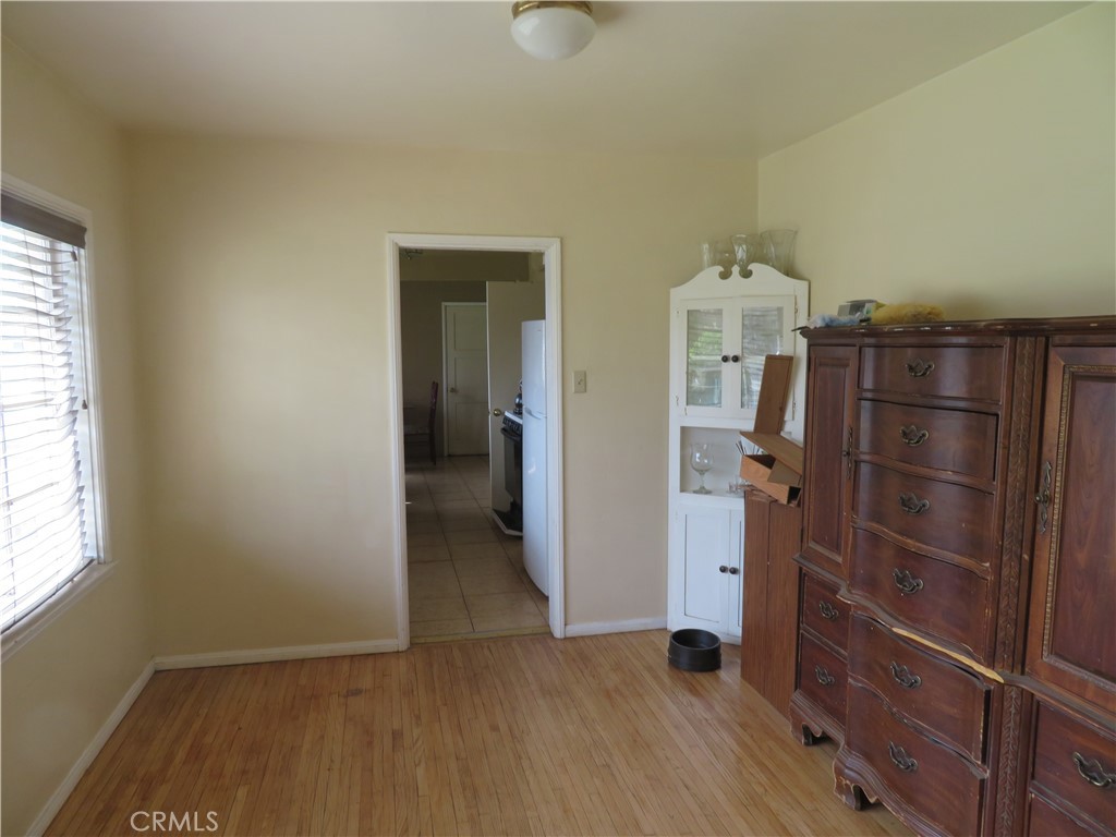 903 Ohio Street Redlands, CA 92374 - Photo 5 of 5 an empty room with wooden floor closet and windows