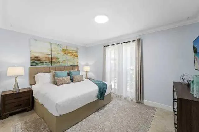 a view of a swimming pool with an outdoor seating and plants