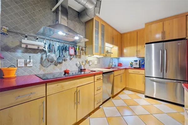 a kitchen with a sink appliances and cabinets