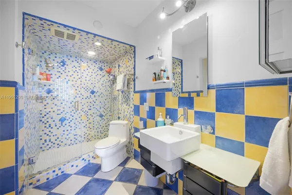 a bathroom with a sink toilet and shower