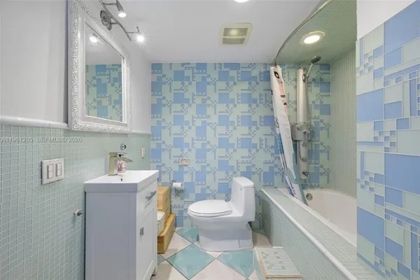 a bathroom with a bathtub shower sink mirror and toilet