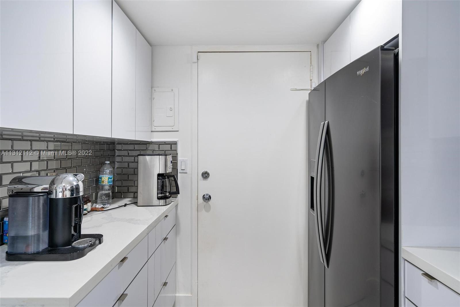 1450 Lincoln Road, Unit 403 Miami Beach, FL 33139 - Photo 11 of 21 a kitchen with a refrigerator and a stove