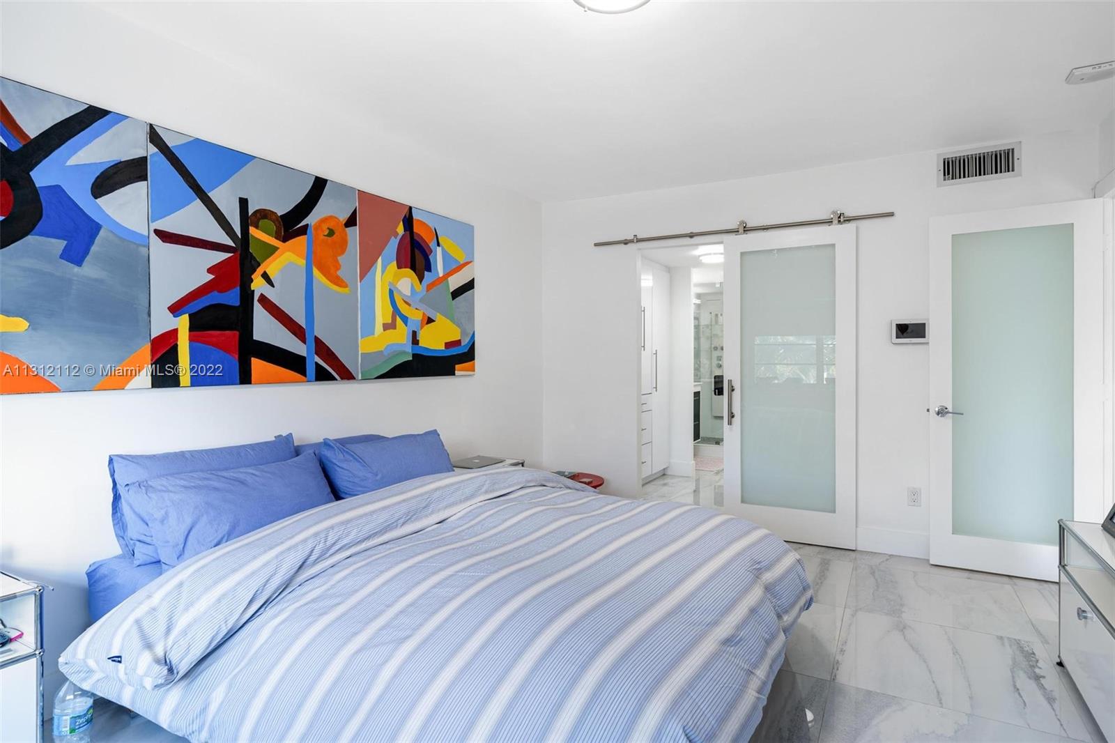 1450 Lincoln Road, Unit 403 Miami Beach, FL 33139 - Photo 12 of 21 a bedroom with a bed and a painting on the wall