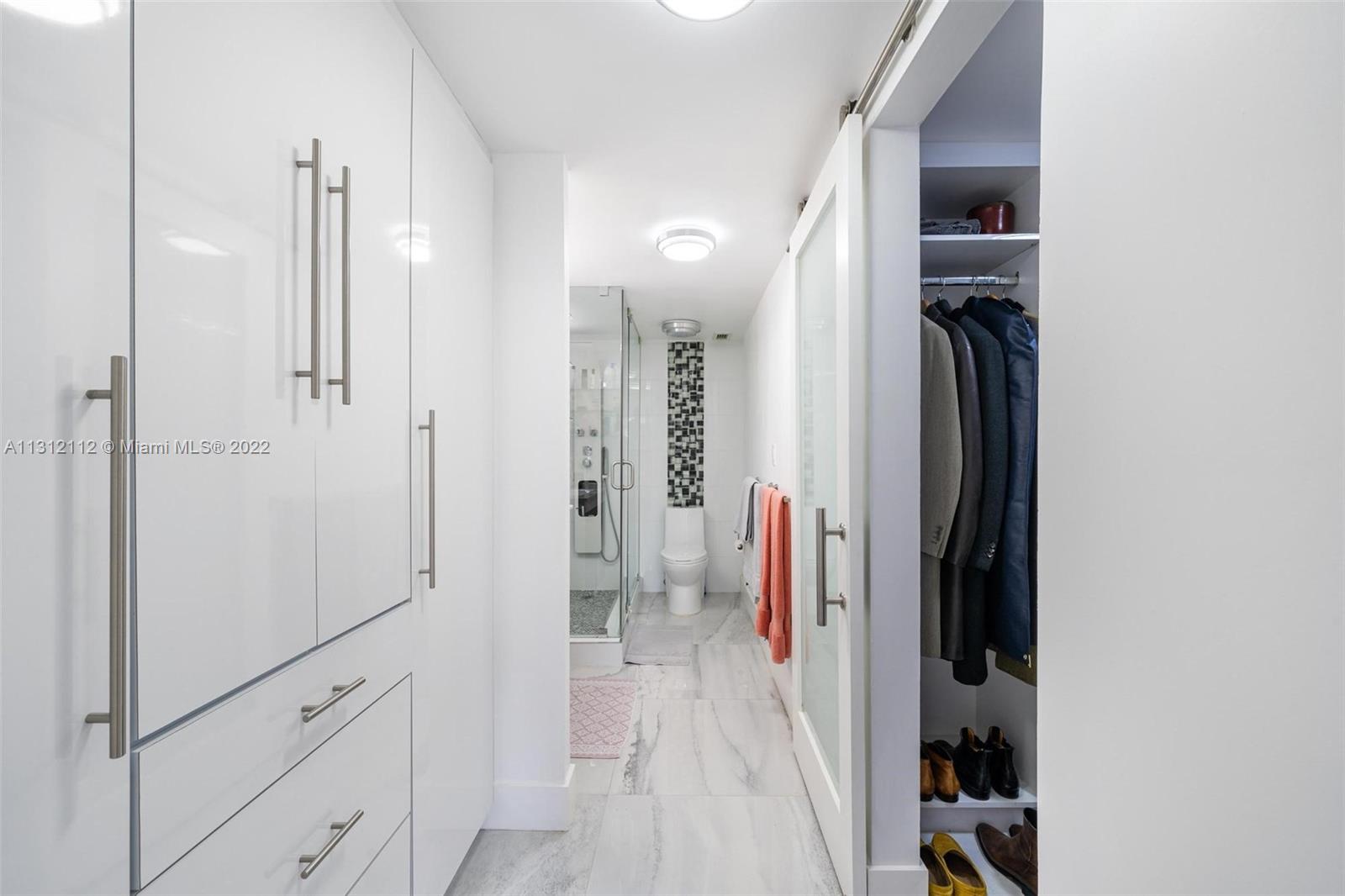 1450 Lincoln Road, Unit 403 Miami Beach, FL 33139 - Photo 14 of 21 a view of walk in closet with clothes