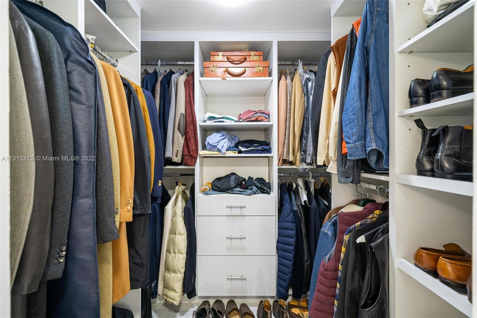 1450 Lincoln Road, Unit 403 Miami Beach, FL 33139 - Photo 15 of 21 a view of walk in closet with clothes and shoes