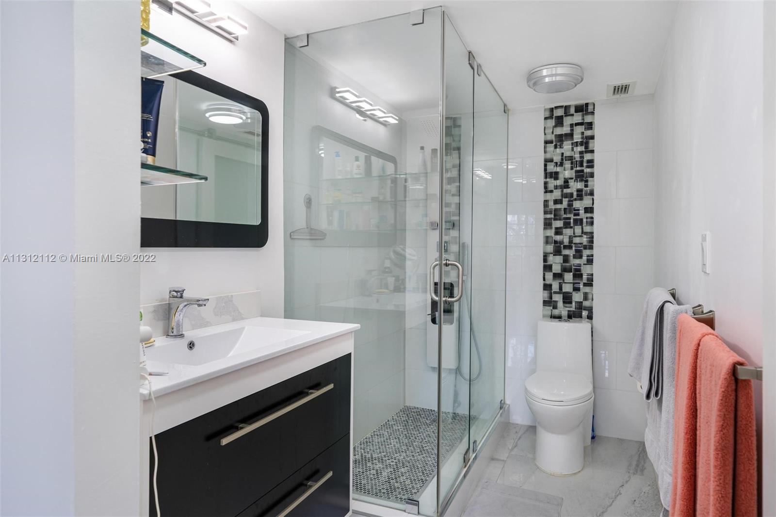 1450 Lincoln Road, Unit 403 Miami Beach, FL 33139 - Photo 16 of 21 a bathroom with a sink toilet and shower