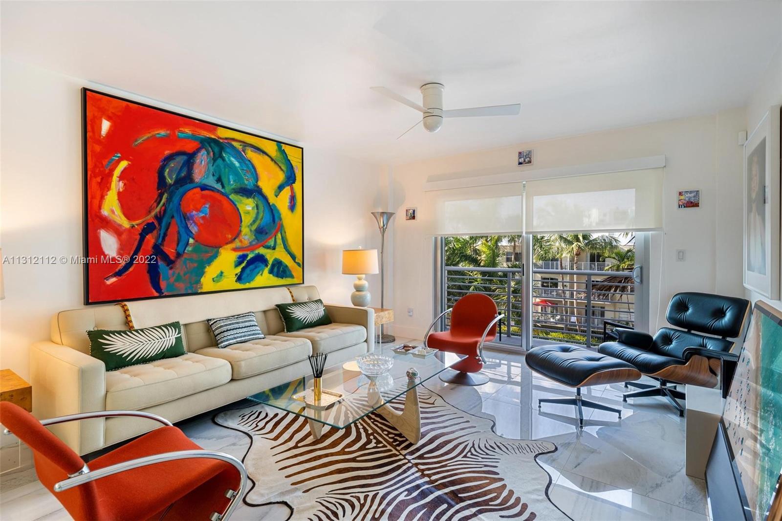 1450 Lincoln Road, Unit 403 Miami Beach, FL 33139 - Photo 2 of 21 a living room with furniture a rug and a window