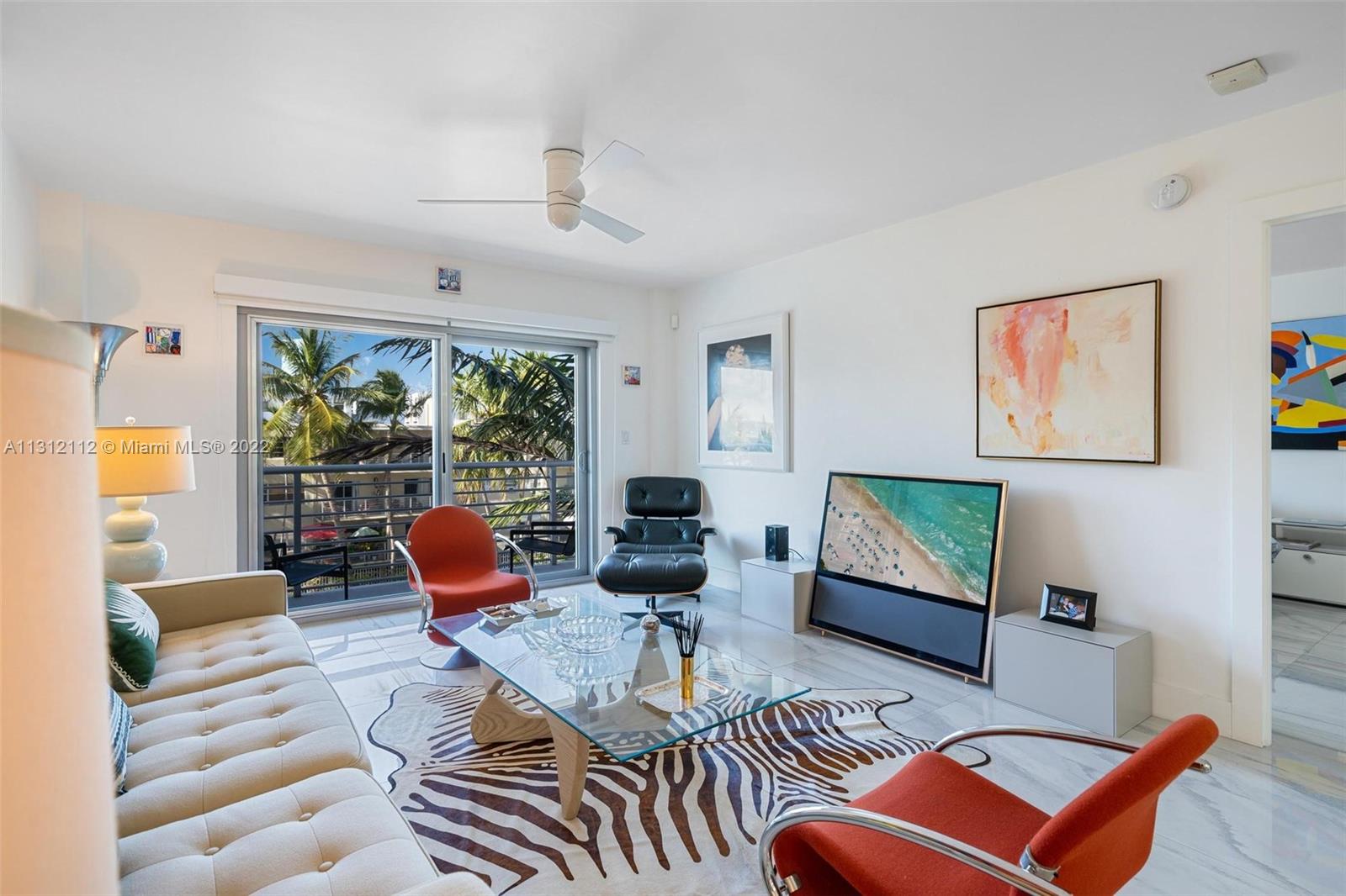 1450 Lincoln Road, Unit 403 Miami Beach, FL 33139 - Photo 3 of 21 a living room with furniture a rug and a large window