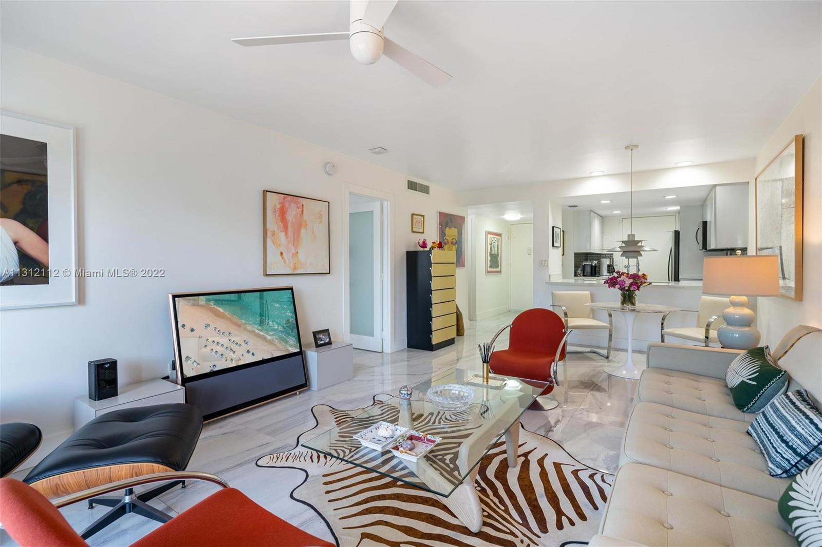 1450 Lincoln Road, Unit 403 Miami Beach, FL 33139 - Photo 6 of 21 a living room with furniture and a flat screen tv