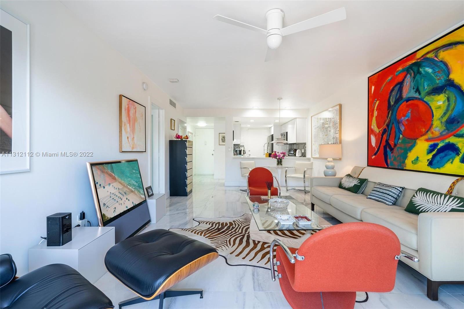 1450 Lincoln Road, Unit 403 Miami Beach, FL 33139 - Photo 7 of 21 a living room with furniture and a flat screen tv
