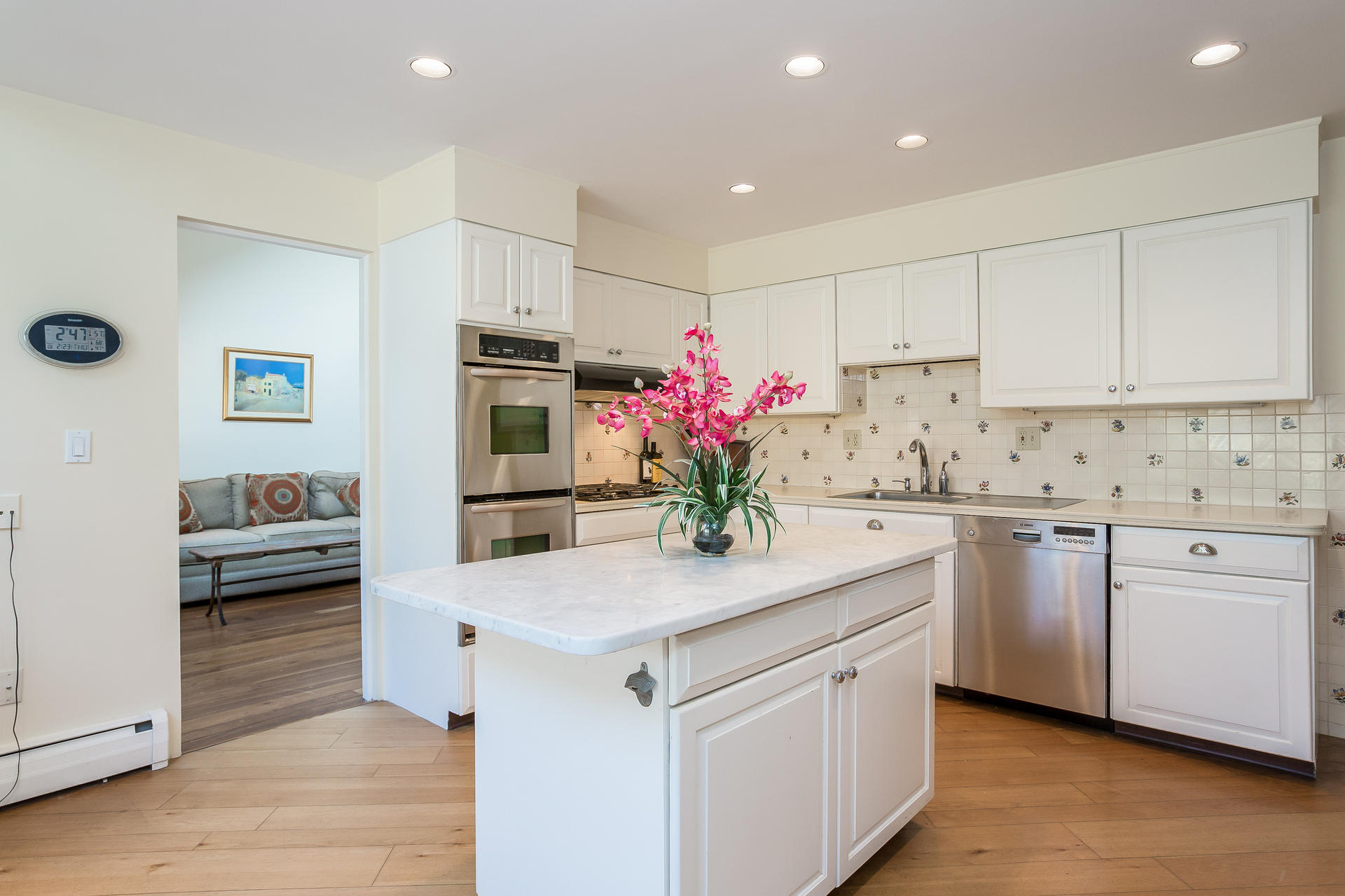 400 Middlesex Road Darien, CT 06820 - Photo 9 of 24 a kitchen with granite countertop white cabinets and stainless steel appliances