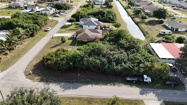 an aerial view of a house with a yard and lake view