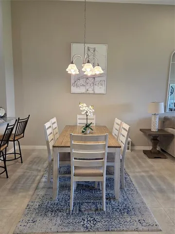 a dining room with furniture a rug and a chandelier