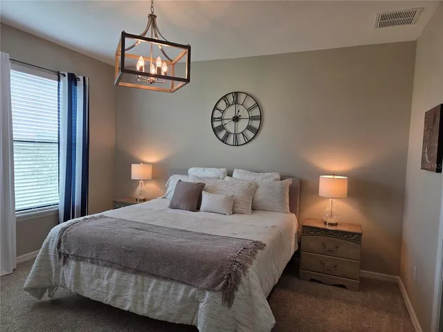 a bedroom with a bed and a lamp