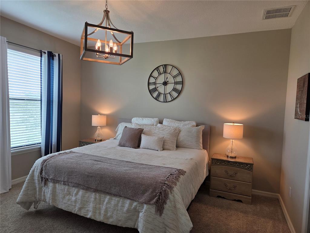 13703 Messina Loop, Unit 202 Bradenton, FL 34211 - Photo 15 of 42 a bedroom with a bed and a lamp