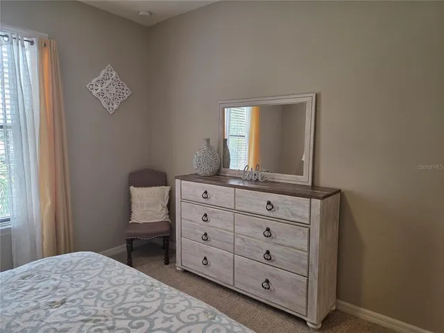 a room with a dresser and a window