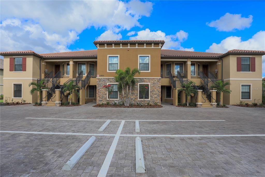 13703 Messina Loop, Unit 202 Bradenton, FL 34211 - Photo 2 of 42 a view of a building with a street