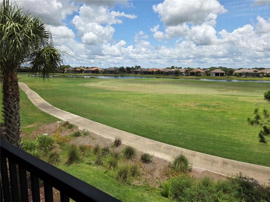 13703 Messina Loop, Unit 202 Bradenton, FL 34211 - Photo 25 of 42 a view of a lake with a big yard
