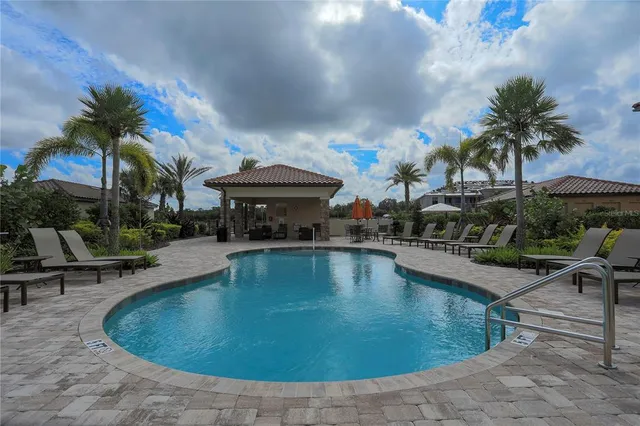 an outdoor space with swimming pool and furniture