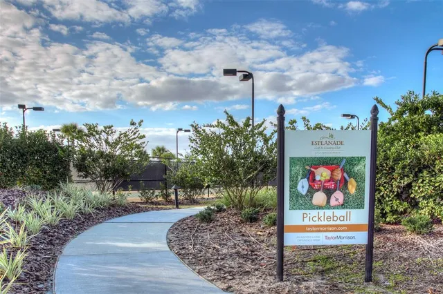 a sign board with buildings in the background