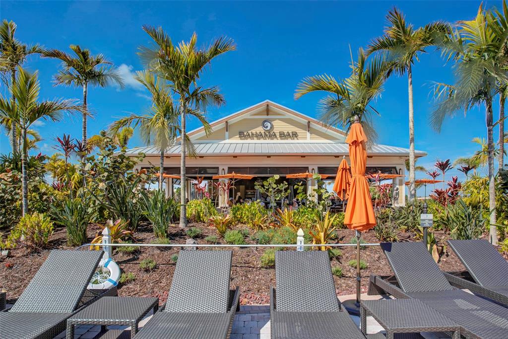 13703 Messina Loop, Unit 202 Bradenton, FL 34211 - Photo 39 of 42 a view of a chairs and table in a backyard