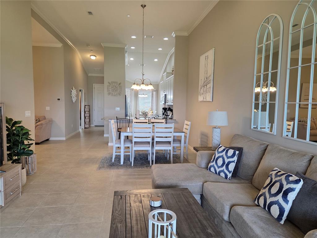 13703 Messina Loop, Unit 202 Bradenton, FL 34211 - Photo 5 of 42 a living room with furniture a large window and chairs