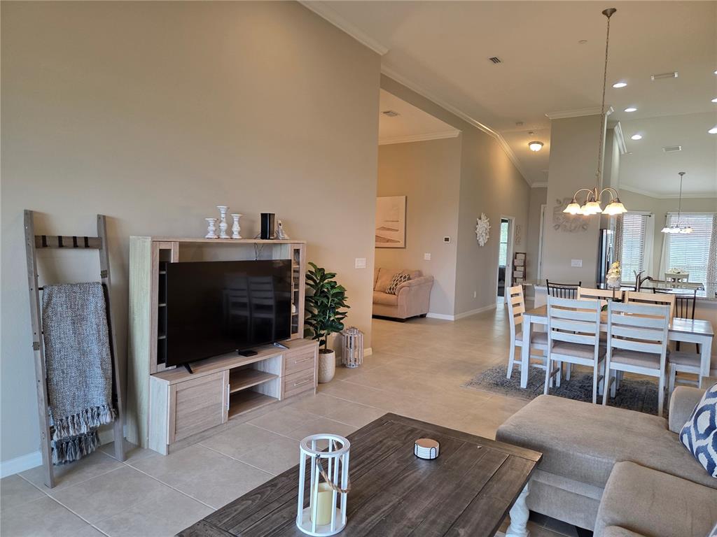 13703 Messina Loop, Unit 202 Bradenton, FL 34211 - Photo 7 of 42 a living room with furniture and a flat screen tv