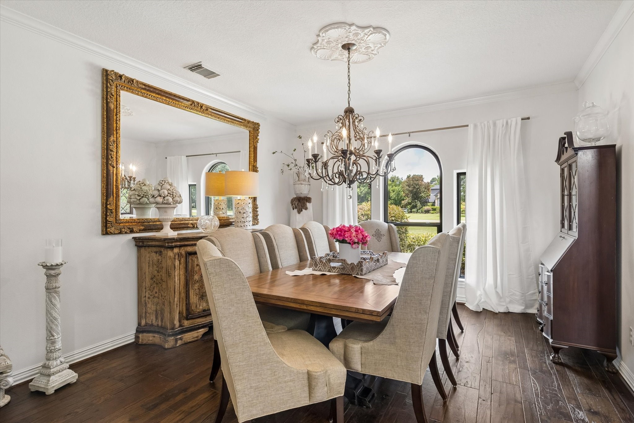 6819 Still Meadow Street Spring, TX 77389 - Photo 7 of 50 The elegant dining room features a stunning chandelier and large arched windows overlooking the front yard