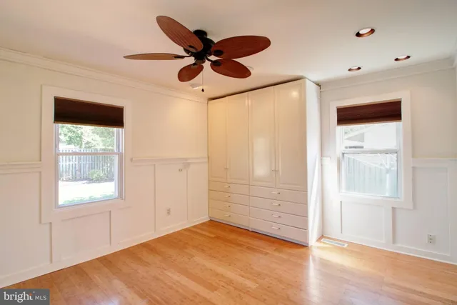 a view of a livingroom with a ceiling fan and window
