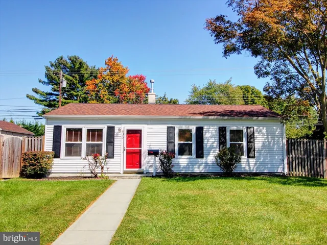 a front view of house with yard and outdoor seating