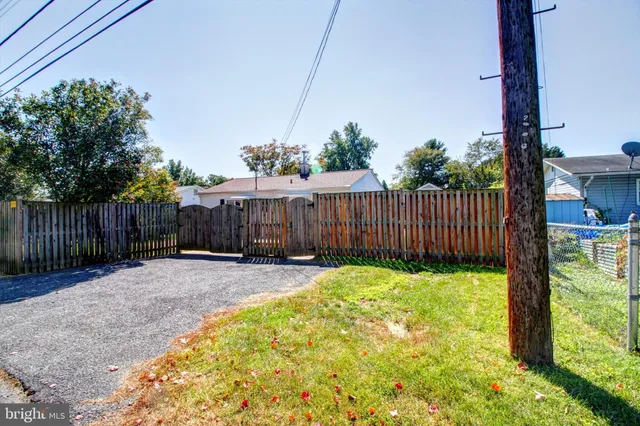 a view of a backyard with wooden fence