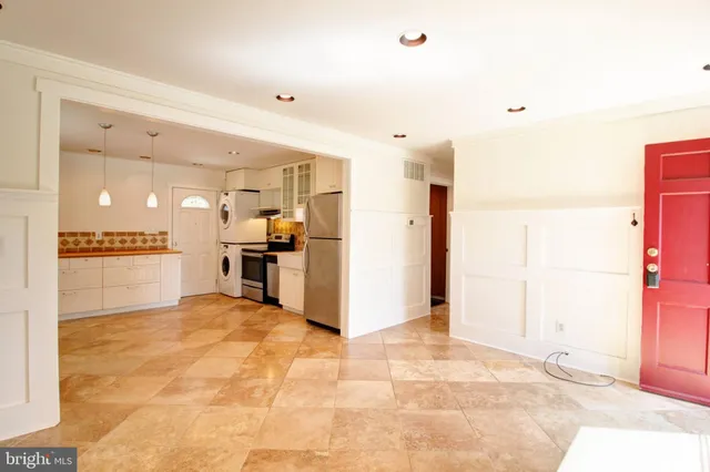 a view of a kitchen with refrigerator and a stove