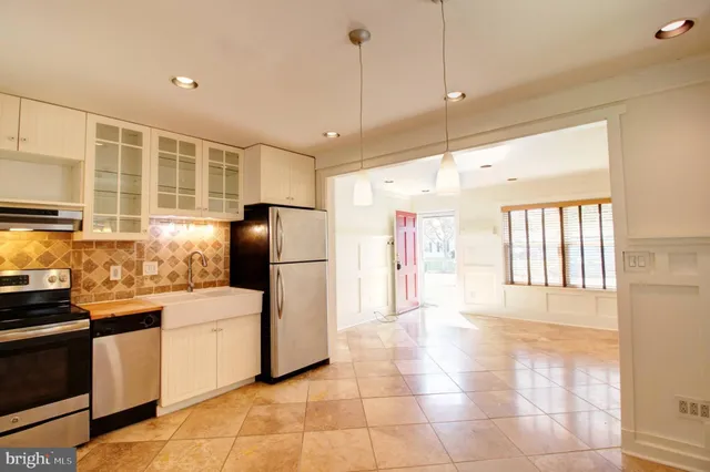 a kitchen with stainless steel appliances granite countertop a refrigerator and a sink
