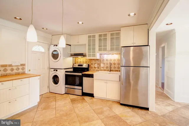a kitchen with a refrigerator a stove top oven a sink and dishwasher
