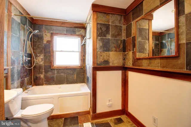 a bathroom with a bathtub and a shower