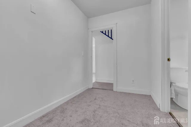 a bathroom with a white tub a potted plant and a window
