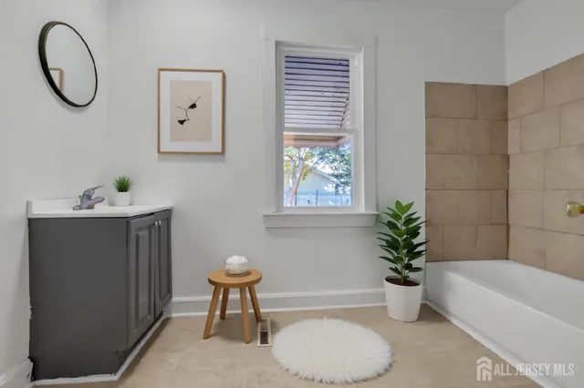 a bathroom with a bath tub and a window