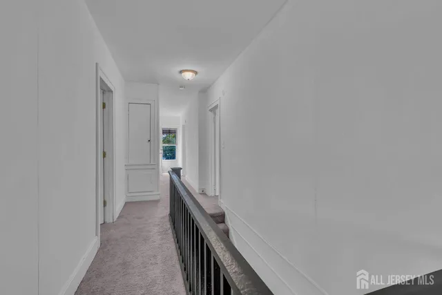 a spacious bedroom with a bed and a lamp