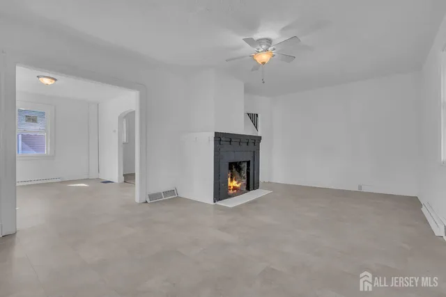 a view of an empty room with a fireplace