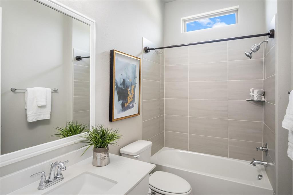 7411 Joshua Road Frisco, TX 75033 - Photo 20 of 40 a bathroom with a sink a toilet a shower curtain and a bath tub