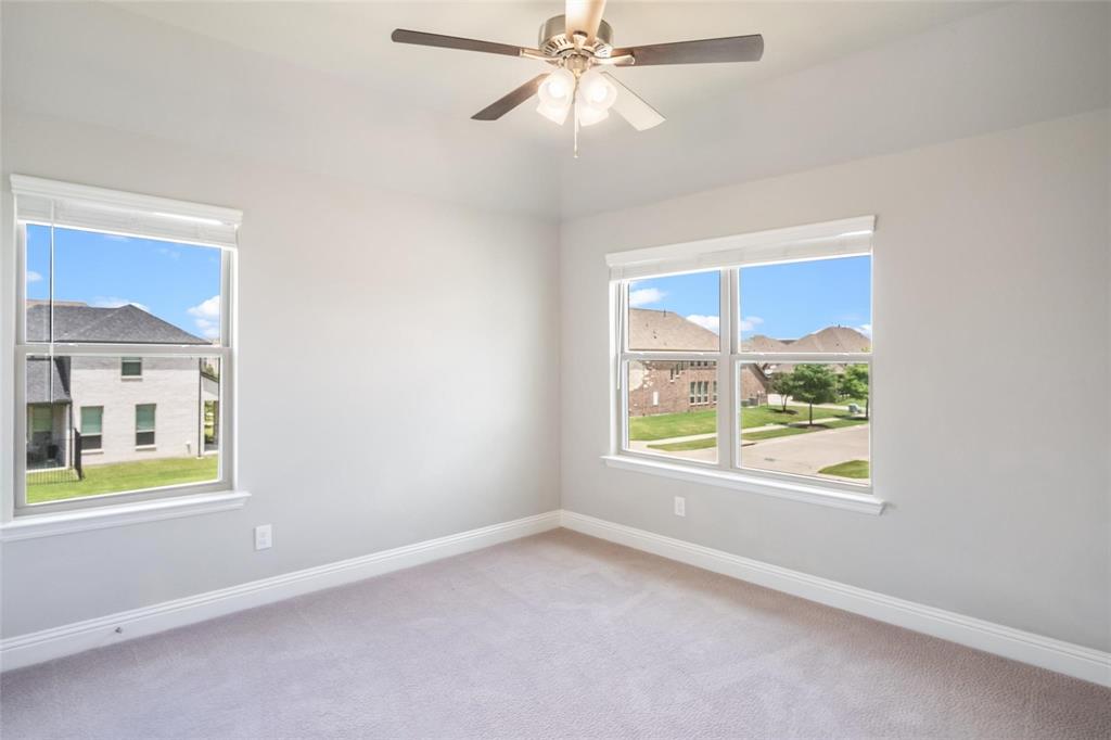 7411 Joshua Road Frisco, TX 75033 - Photo 28 of 40 an empty room with a window and a ceiling fan